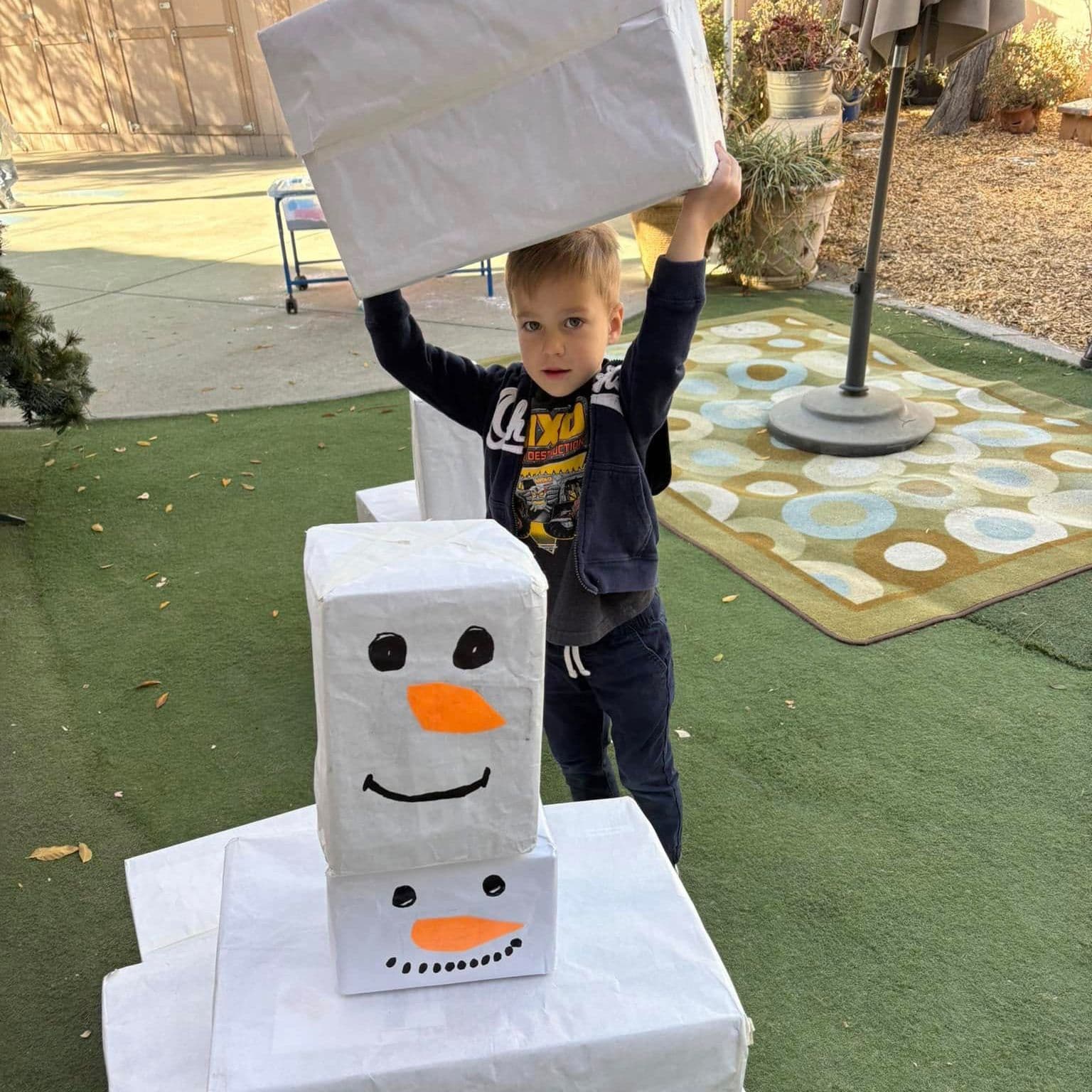 A boy building a snowman